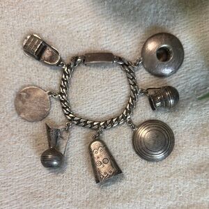 Small Silver Charm Bracelet purchased and made in Mexico. 7.5 inches with clasp